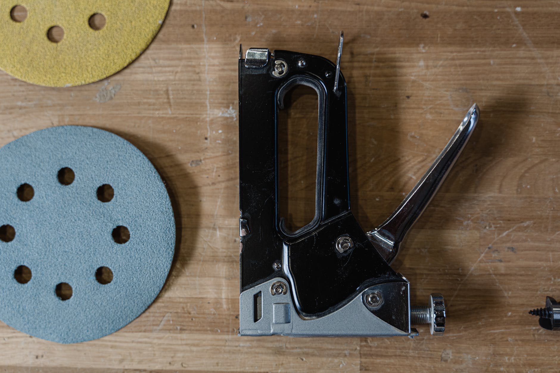 gun tacker on wooden surface